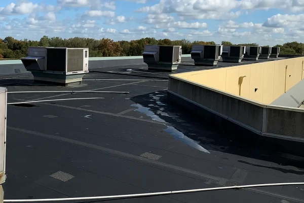 Flat commercial roof with EPDM membrane and multiple HVAC units