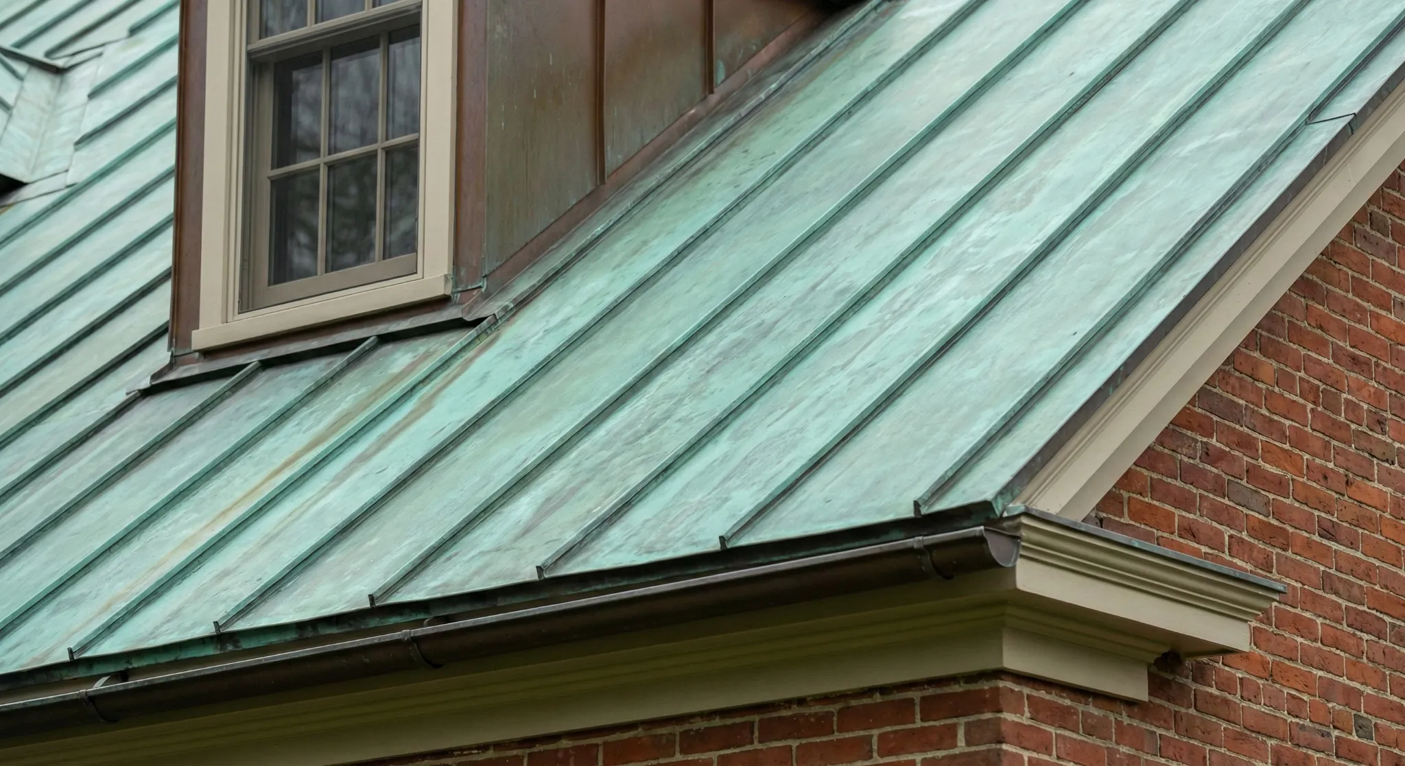 Copper standing-seam roof detail showing a different metal roof profile and edge