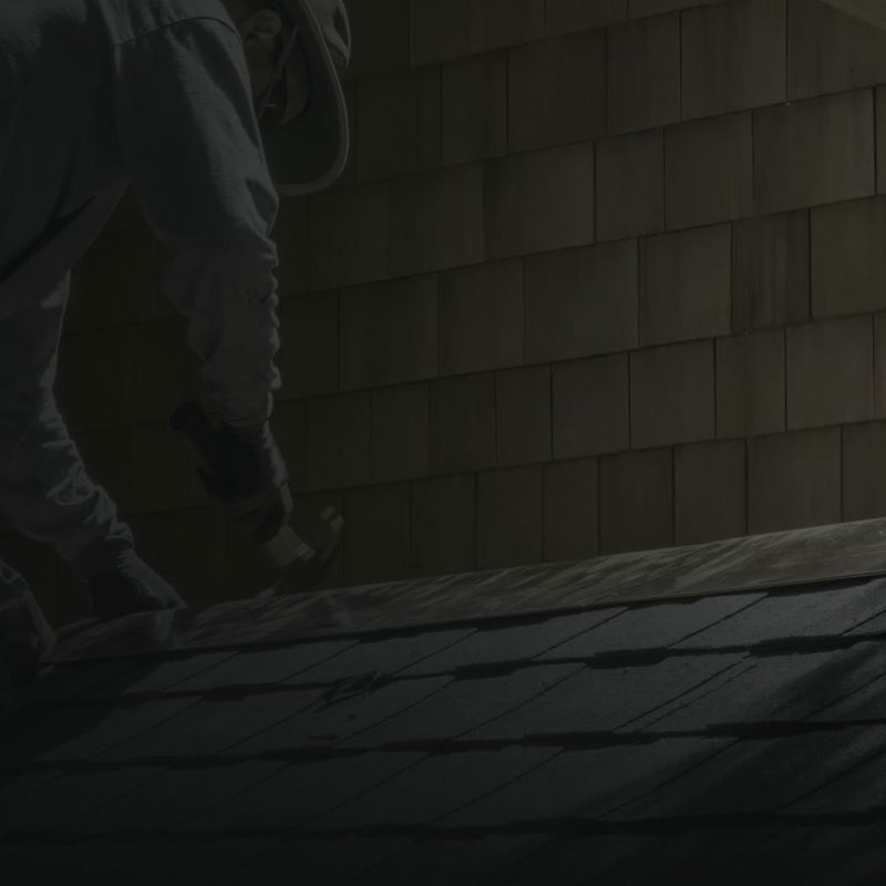 Ellis Builders roofing team member working on a Connecticut home roof