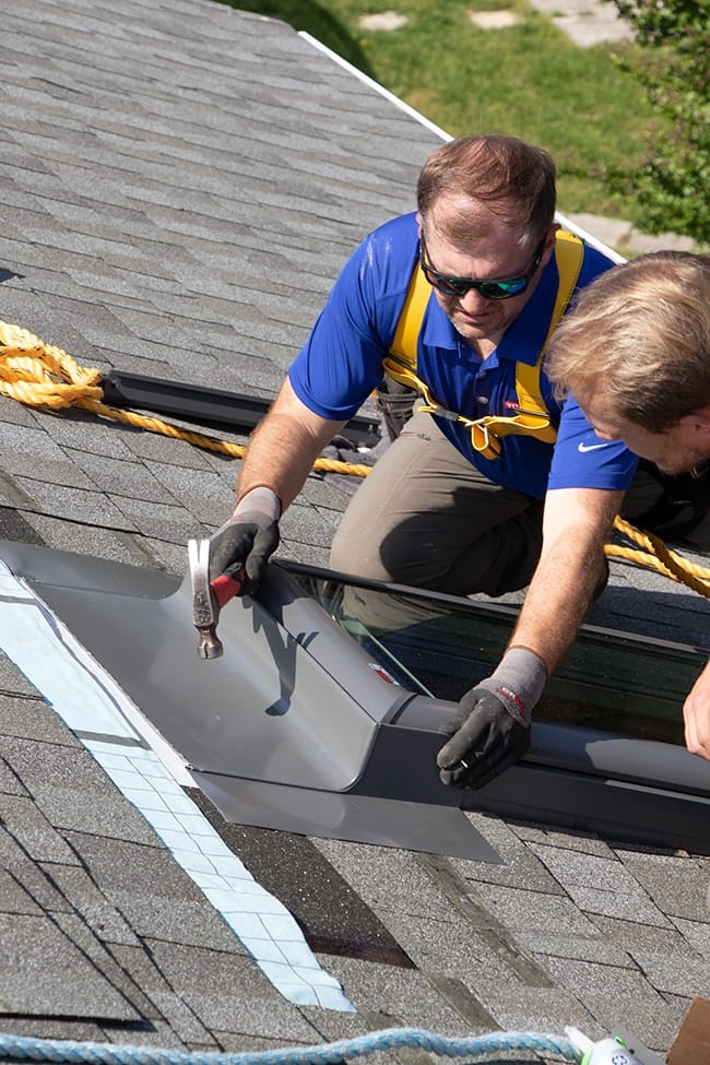 VELUX skylight installer nailing skylight flashing in place