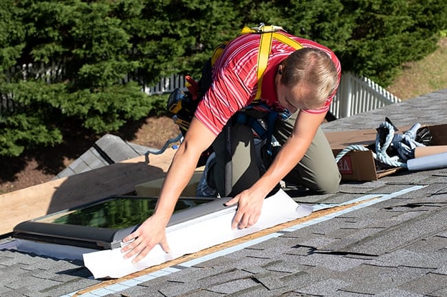 VELUX skylight installer adding all weather underlayment around a skylight